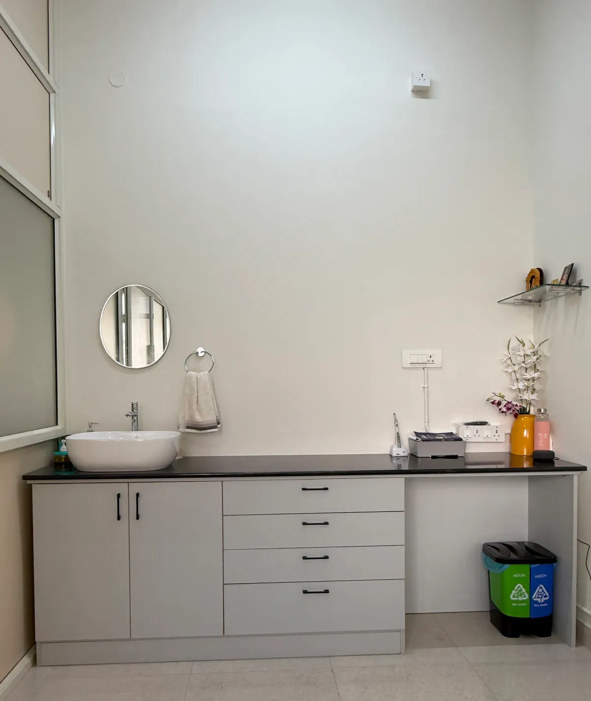 Sink, mirror and storage cabinets beside the clinic treatment area